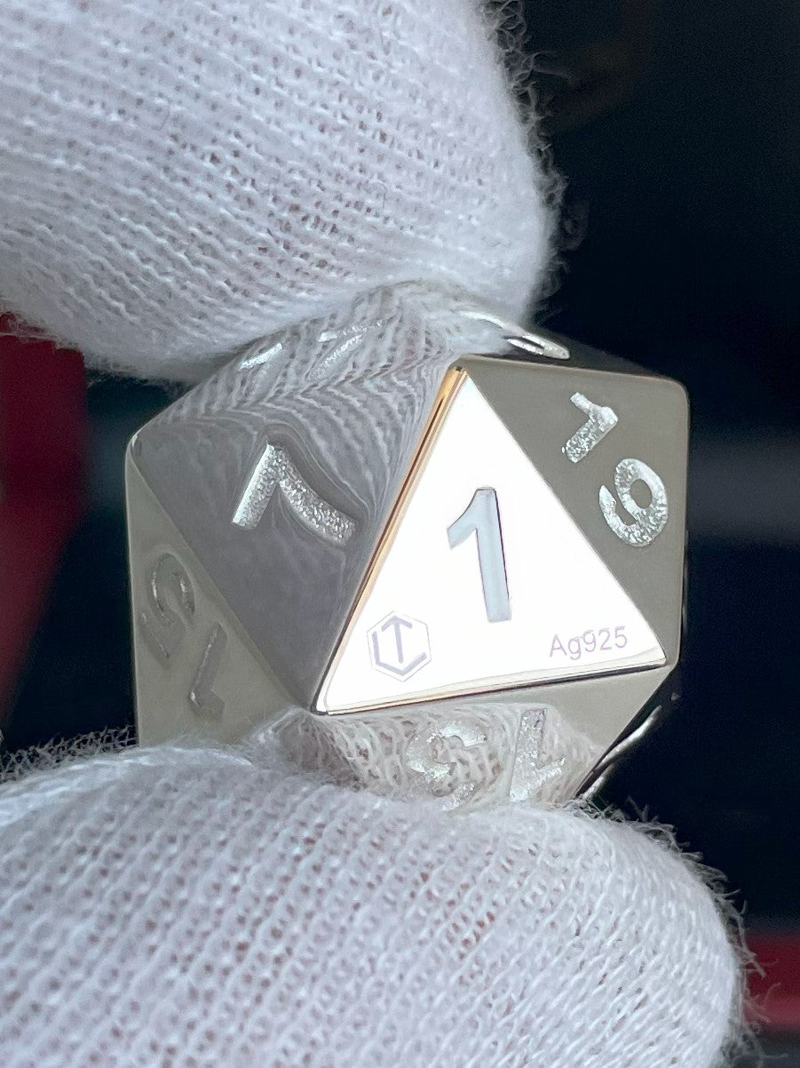D20 Silver Dice polished in hand before black case - D20 Silberwürfel in der Hand