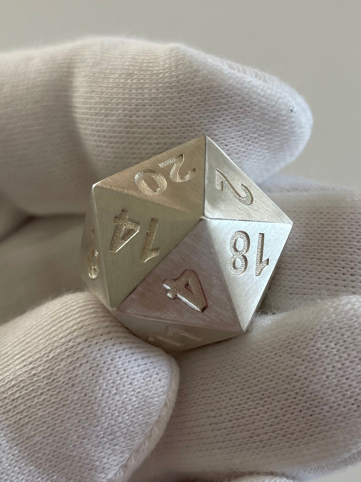 D20 dice in silver brushed in hand - D20 Würfel mattiert in der Hand