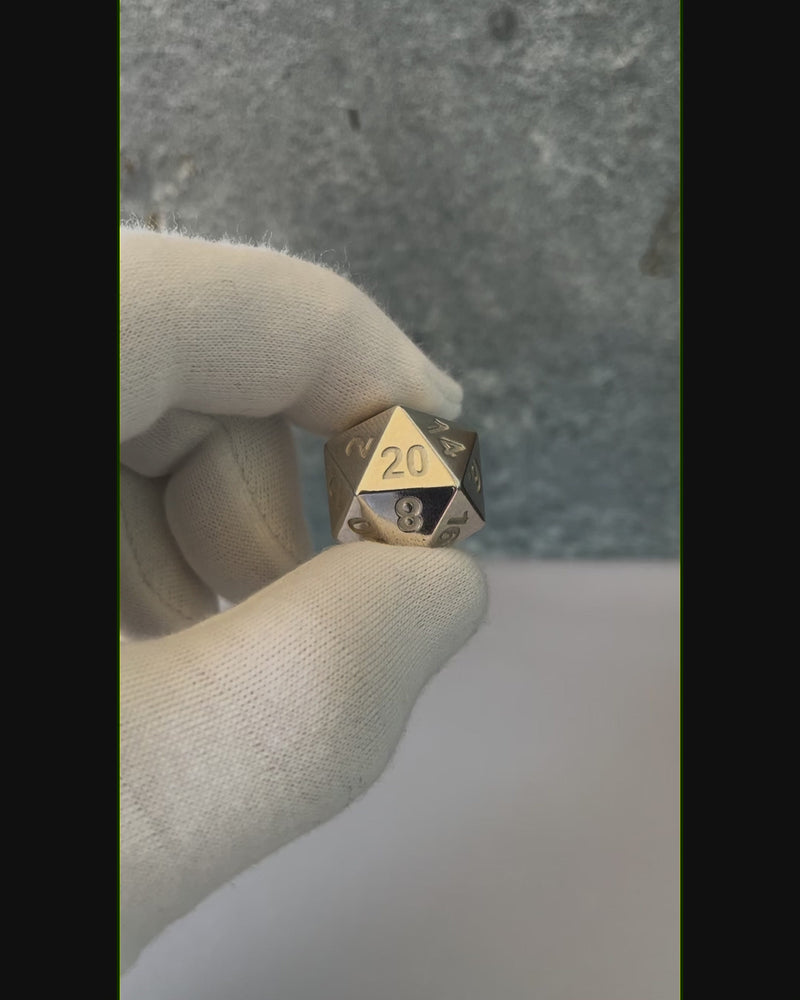 Sterling Silver D20 Dice in hand. 