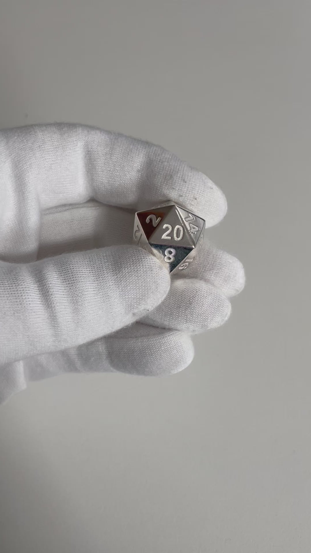 Sterling Silver D20 Dice in hand.