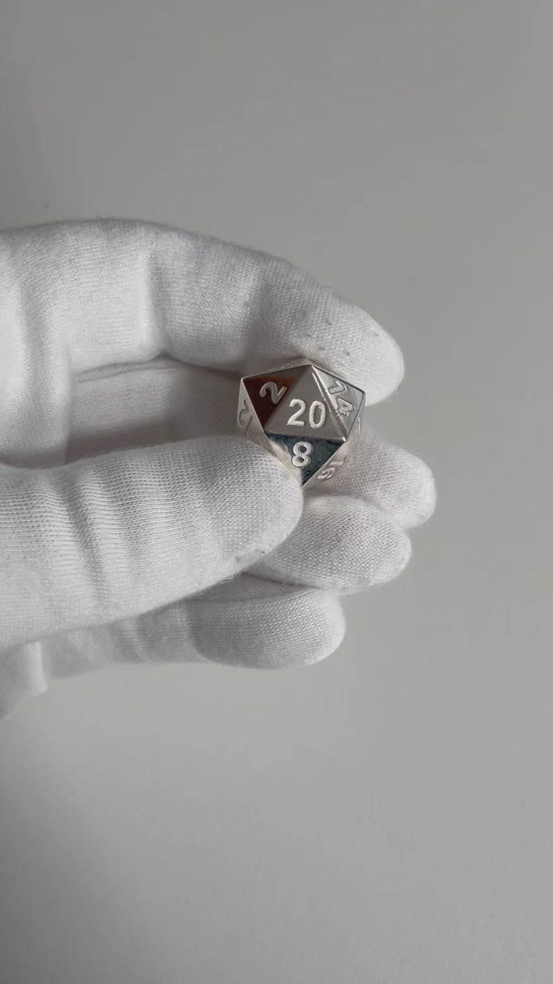Sterling Silver D20 Dice in hand.